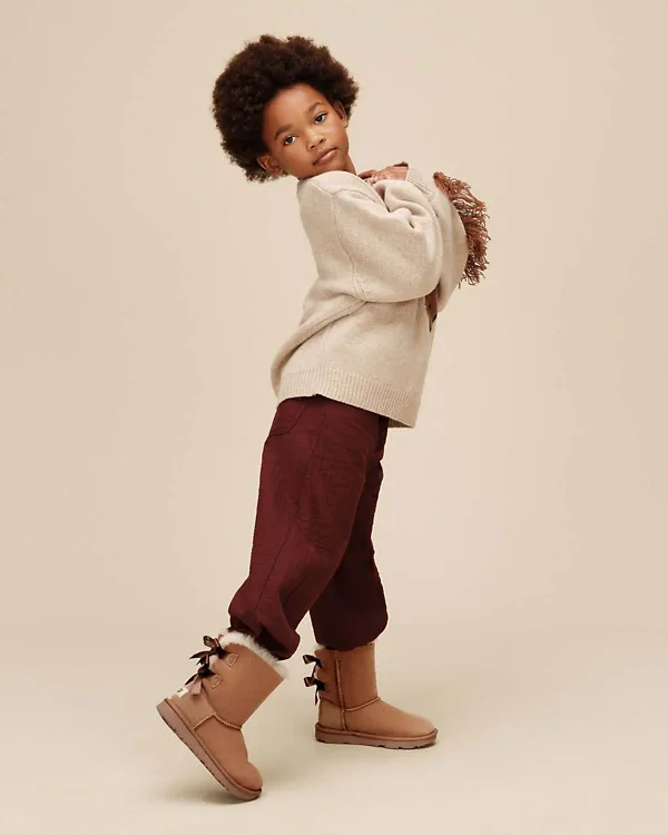 A kid wearing our Bailey Bow II boots.